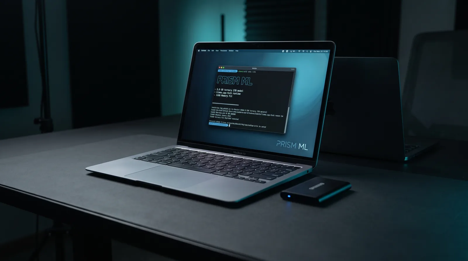 A MacBook Air glowing with a terminal session on a dark desk beside a portable SSD, illustrating a 5.9 GB ternary 27B model running locally on Apple Silicon
