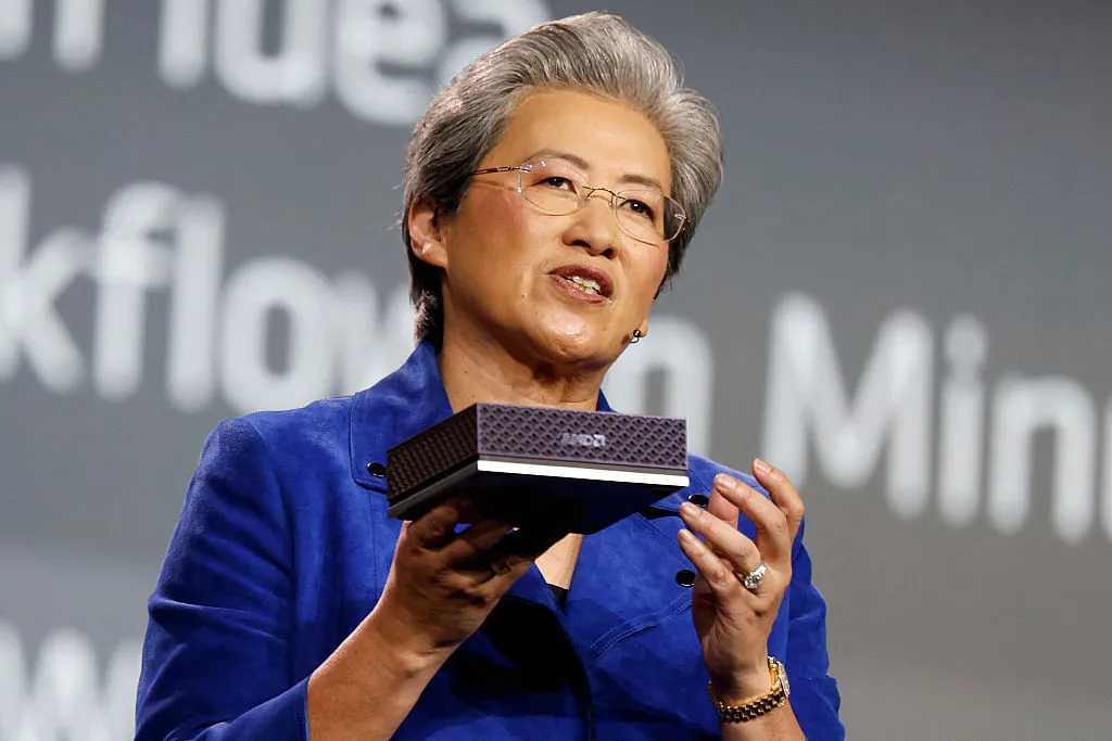 AMD CEO Lisa Su holds the Ryzen AI Max+ 395 Strix Halo mini PC on stage during a keynote